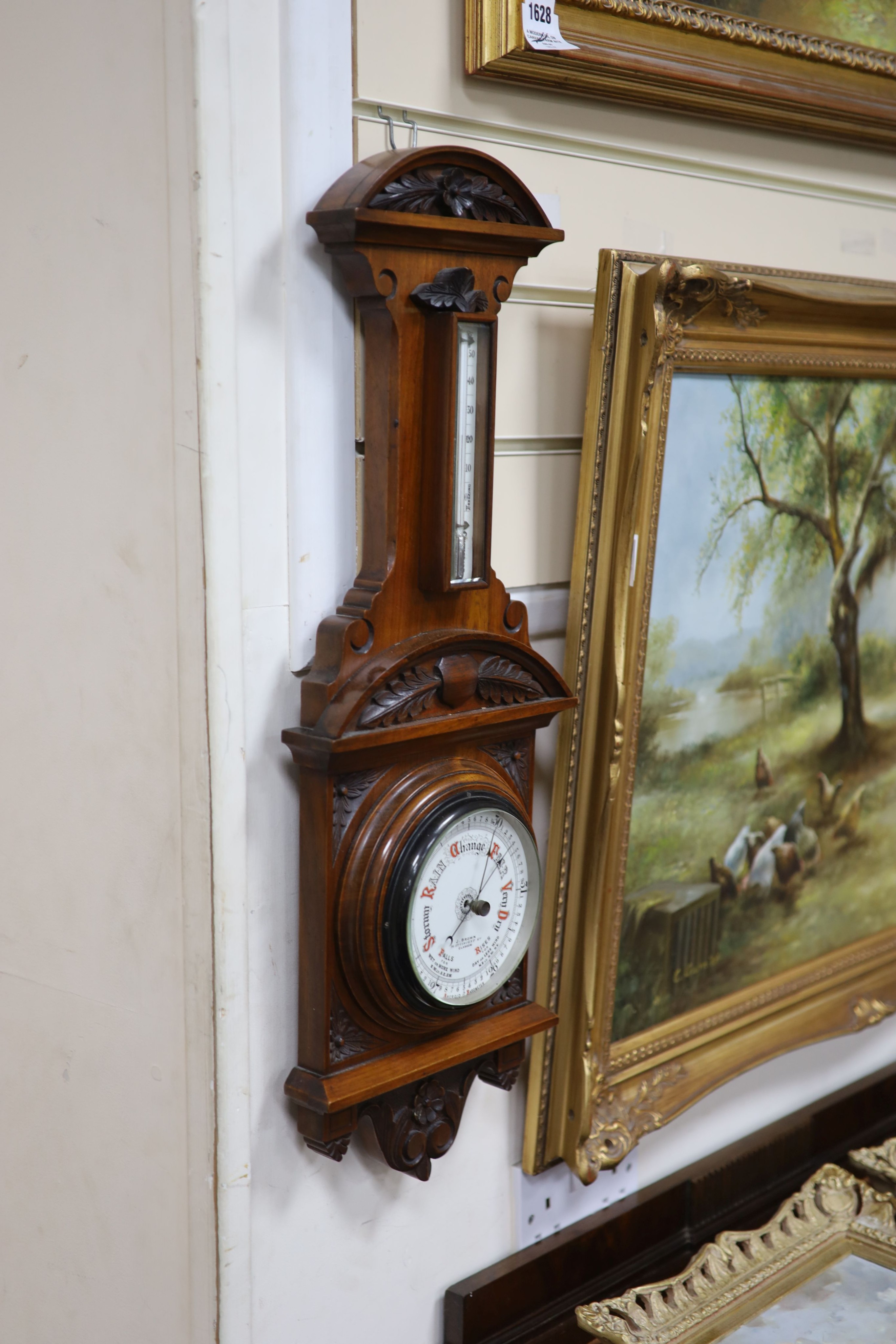 J Brown, Glasgow, a late Victorian carved walnut cased aneroid barometer and thermometer, height 65cm